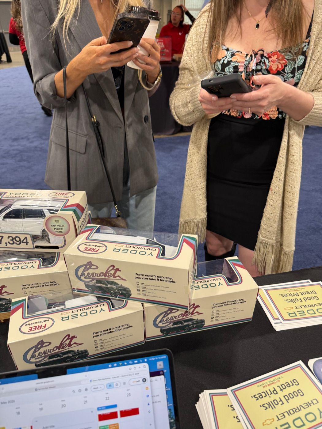 Attendees using their phones around the Motibox boxes at the Colorado Auto Show